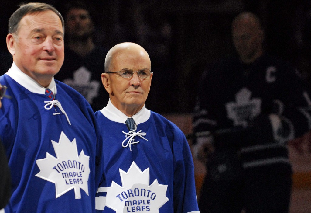 Timmins' Frank Mahovlich, left, and Dave Keon look on during the national anthem following a ceremony honouring the 1967 Stanley Cup Championship team prior to the Maple Leafs game against the Edmonton Oilers in Toronto, Saturday February 17, 2007. Maple Leafs captain Mats Sundin shown in background right. (CP PHOTO/Aaron Harris) CANADA